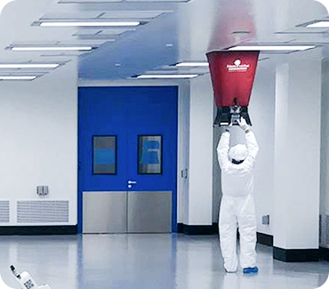 Cleanroom maintenance worker performing equipment service while maintaining contamination protocols