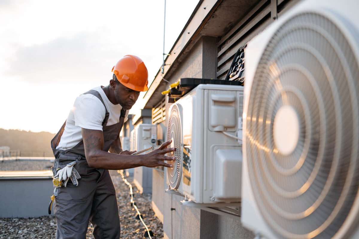 HVAC technician installing climate control system for cleanroom environment maintenance