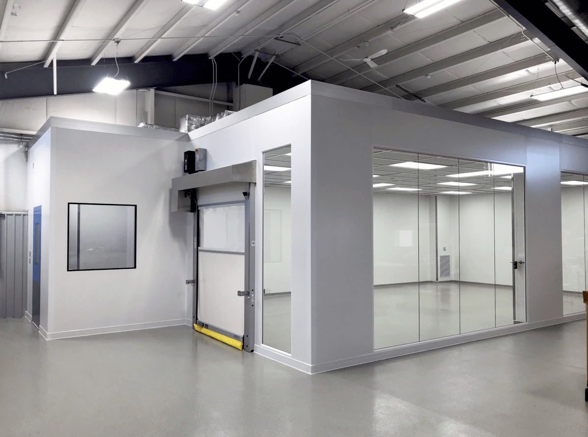 Modular cleanroom construction with glass partitions and contamination control design